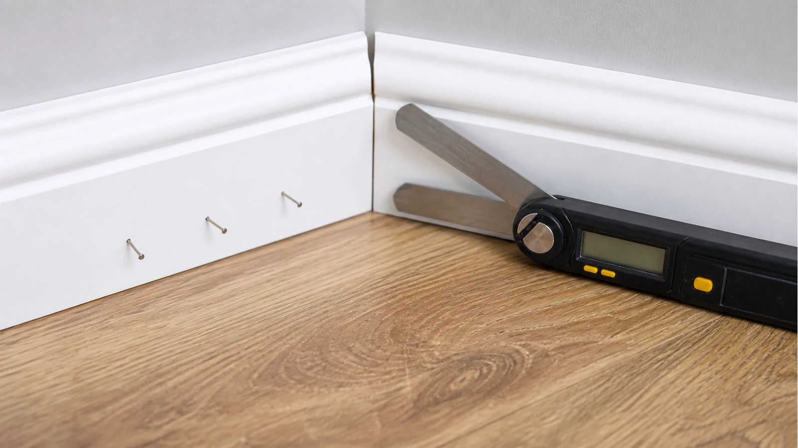 Scotia beading mitre gap at a UK laminate floor corner being measured